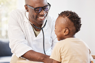 Buy stock photo Shot of a doctor examining an adorable little boy with a stethoscope