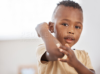 Buy stock photo Black boy, injury and band aid for a cut, portrait and medical with a sore, insect bite and care. Face, male child and young person with a plaster, bandage and medical help with wellness or first aid