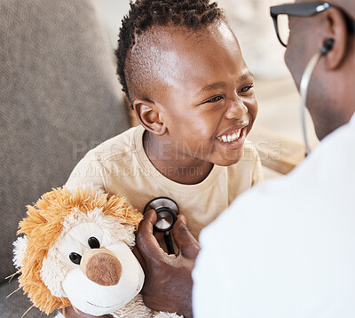 Buy stock photo Shot of a doctor examining an adorable little boy with a stethoscope
