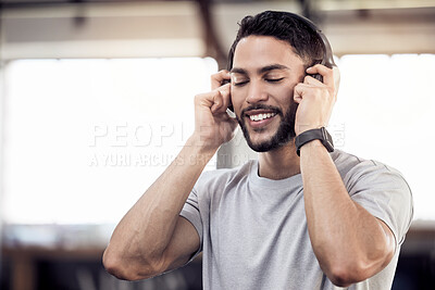 Buy stock photo Headphones, listening to music and a man at gym for exercise, fitness or training workout. Face of happy male athlete listen to audio, sound or radio with tech for motivation, mindset and to relax