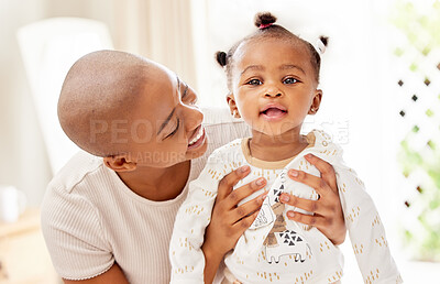 Buy stock photo Shot of a mother bonding with her baby daughter at home