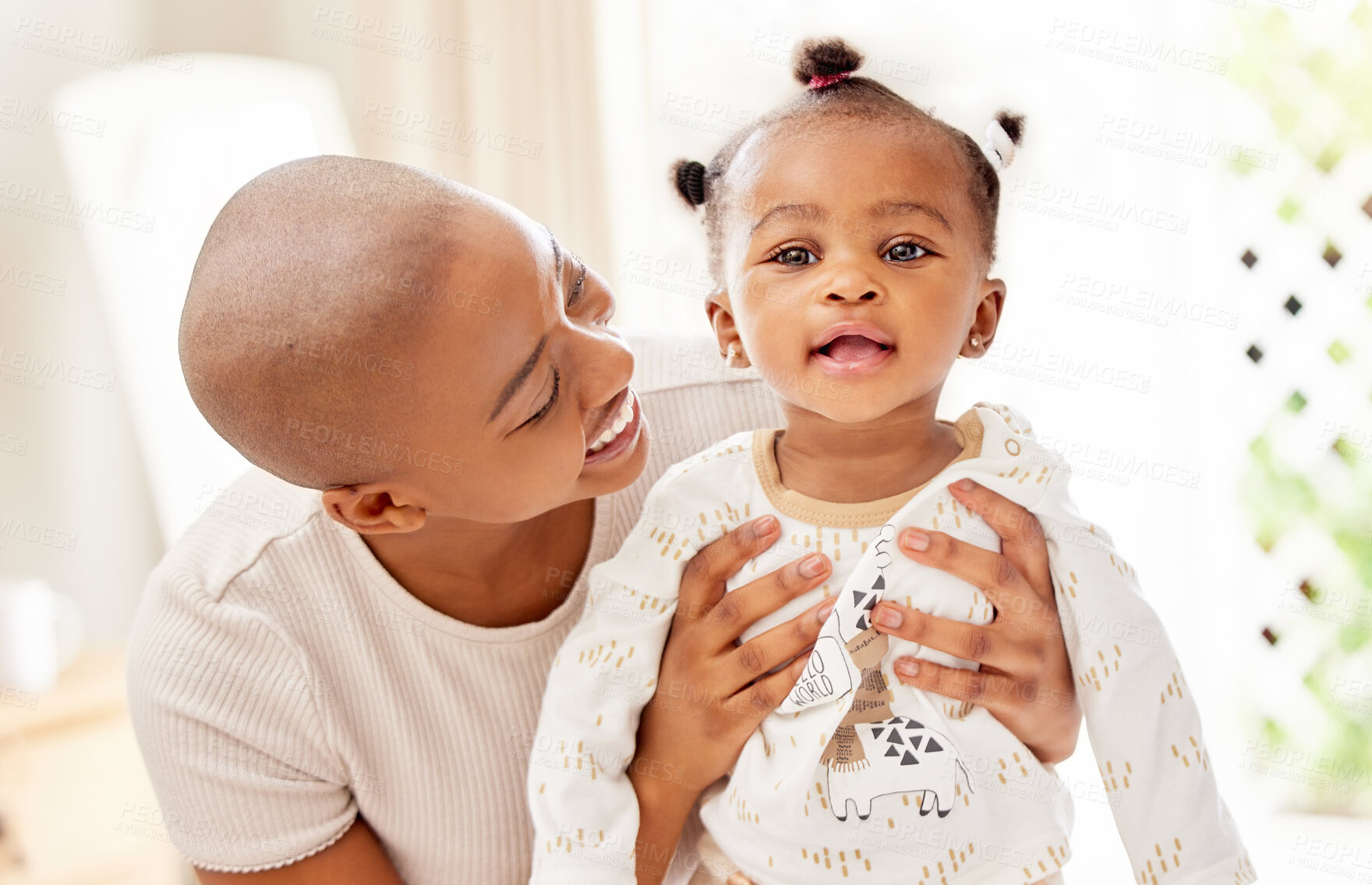 Buy stock photo Shot of a mother bonding with her baby daughter at home