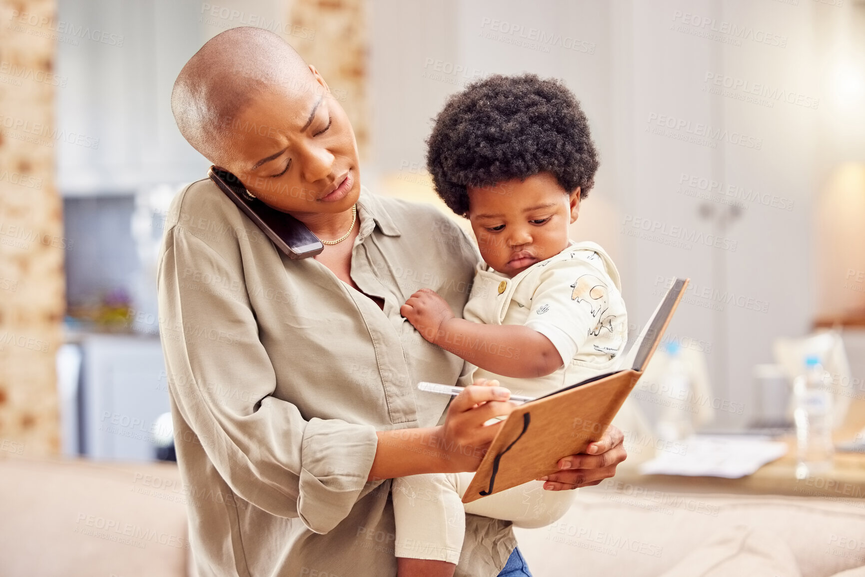 Buy stock photo Shot of a young mother on a call while writing in a notebook at home