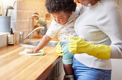 Buy stock photo Shot of a little girl helping her mother clean at home