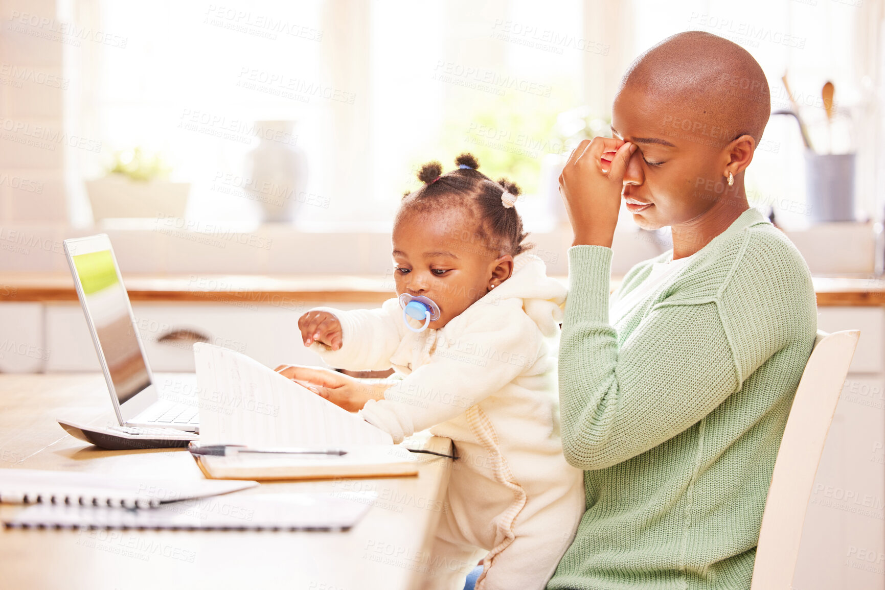 Buy stock photo Multitask, remote work or stress with baby girl and mother in dining room of home for freelance employment. Documents, headache and laptop with daughter on lap of African parent in apartment for work