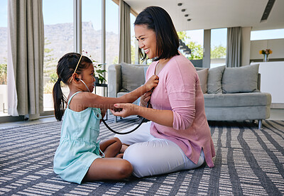 Buy stock photo Happy, parent and kid playing as doctor with stethoscope for child development, learning and fun. Family, bonding and girl listening for heartbeat, with medical tool for growth and education at home