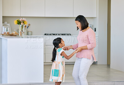 Buy stock photo Mom, girl and happy with dancing in kitchen for support, love and growth or child development. Parent, kid and satisfied at home with playing for bonding, childhood memories and fun together