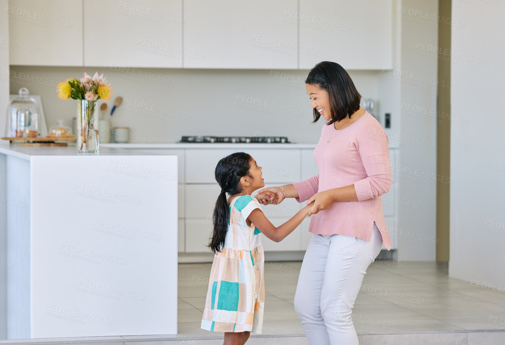 Buy stock photo Mom, girl and happy with dancing in kitchen for support, love and growth or child development. Parent, kid and satisfied at home with playing for bonding, childhood memories and fun together