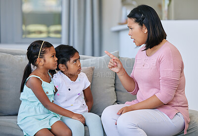 Buy stock photo Mother, pointing and scolding children in house, discipline and communication or strict parent in family home. Living room, girl and sofa for punishment or conflict and behaviour, upset and parenting