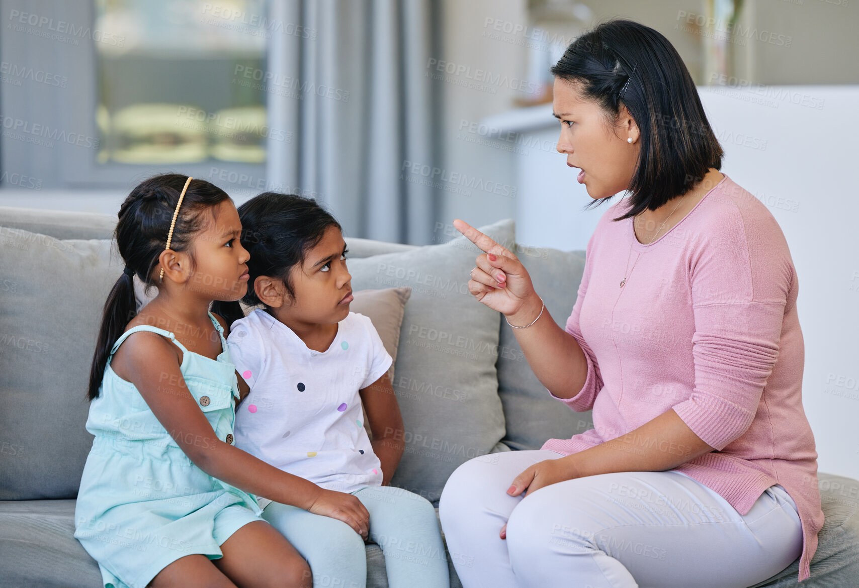 Buy stock photo Mother, pointing and scolding children in house, discipline and communication or strict parent in family home. Living room, girl and sofa for punishment or conflict and behaviour, upset and parenting