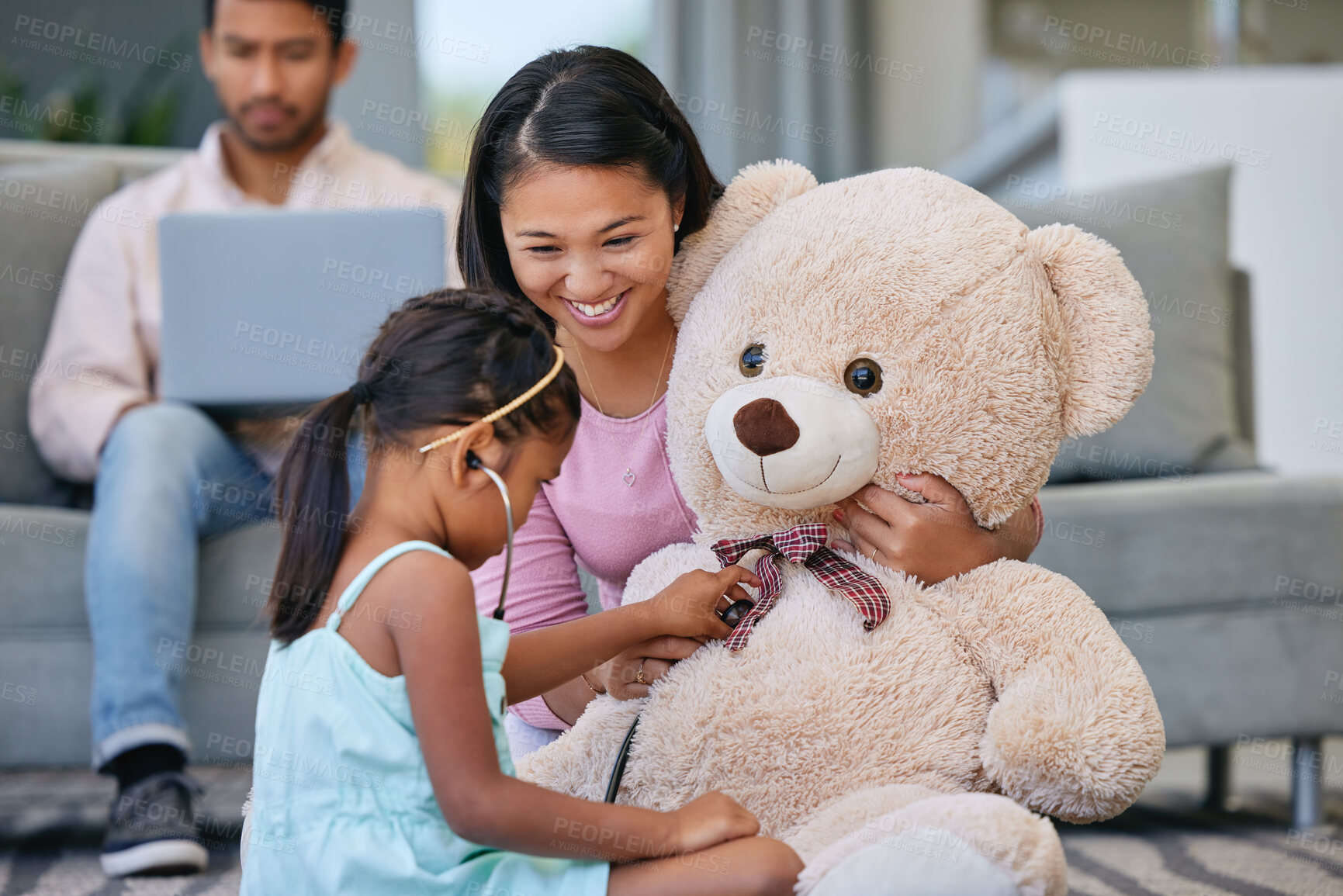 Buy stock photo Mother, girl and play doctor in house, healthcare and parents in family home with father for health insurance. Child, stethoscope and learning medical care on teddy bear, heartbeat and education