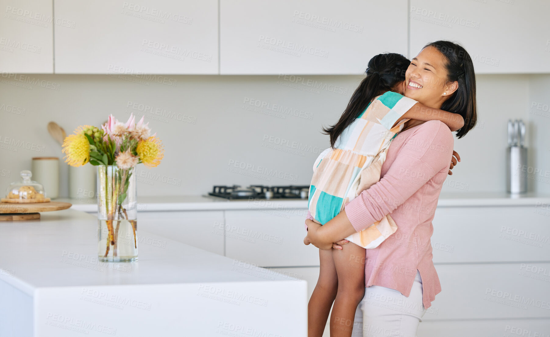 Buy stock photo Mom, girl and happy with hug in kitchen for support, love and growth or child development. Parent, kid and satisfied at home with playing for bonding, childhood memories and fun together with smile