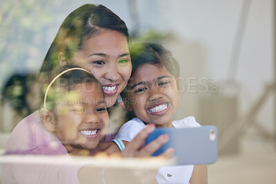 Buy stock photo Shot of a young woman taking selfies with her daughters