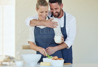 Buy stock photo Shot of a young couple cooking together at home