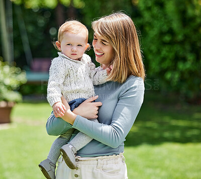 Buy stock photo Shot of a mother and son affectionately bonding in the backyard at home