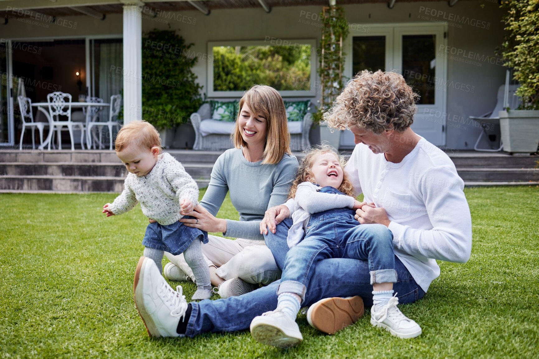 Buy stock photo Mom, dad and kids playing in backyard with smile, bonding and playful fun on calm summer weekend. Happy family, parents and children together on grass in home garden with games, love and support