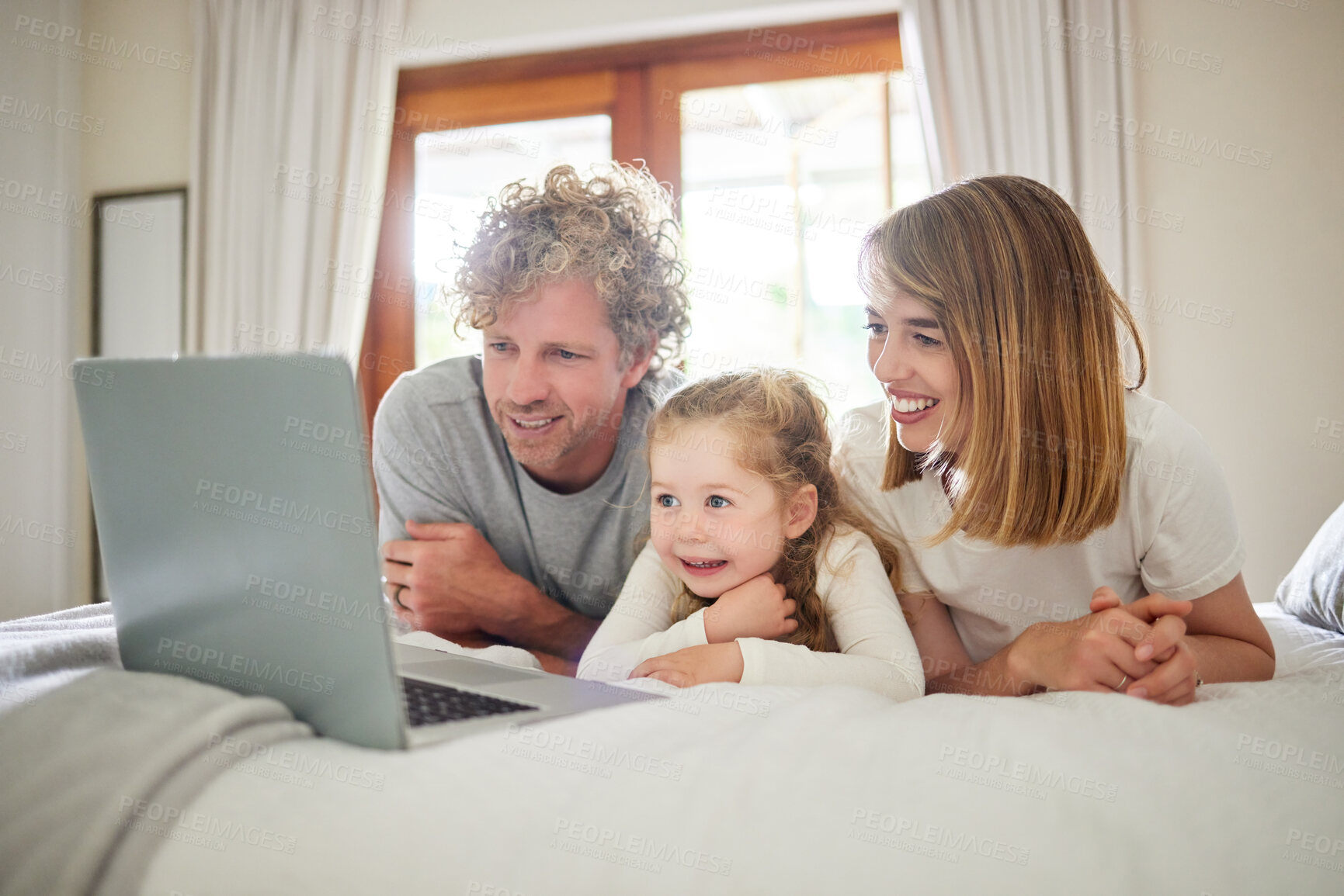 Buy stock photo Child, parents and relax with laptop on bed, house and bonding, watching movie or streaming online for entertainment. Family, girl and together on internet with care, subscription or cartoon film