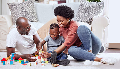 Buy stock photo Building blocks, toys and black family playing on a living room floor happy, love and bonding in their home. Child development, learning and kid with parents in a lounge with alphabet, shape and game