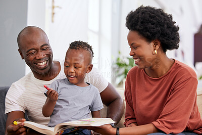 Buy stock photo Shot of a little boy drawing with crayons while sitting with his parents