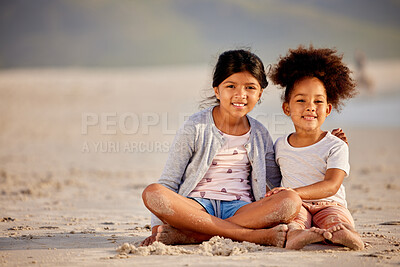 Buy stock photo Shot of  two sisters spending time together at the beach
