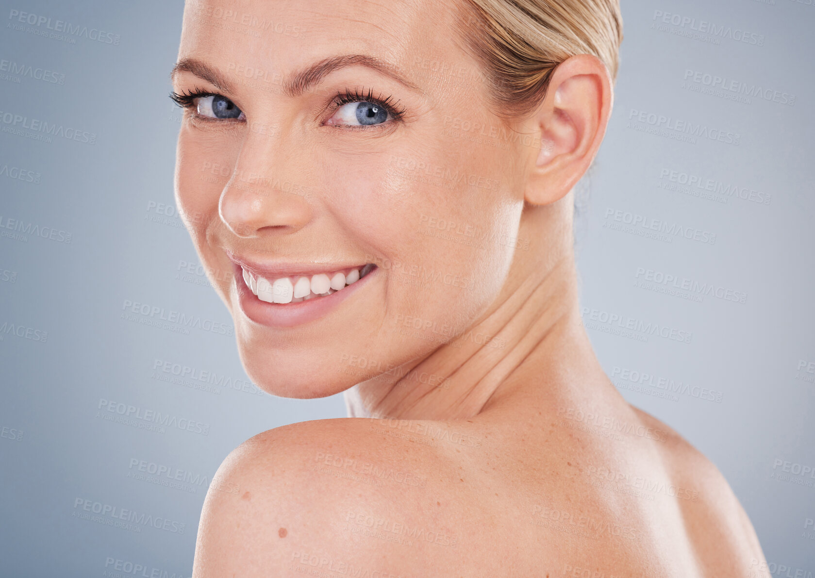 Buy stock photo Studio portrait of an attractive young woman posing against a grey background