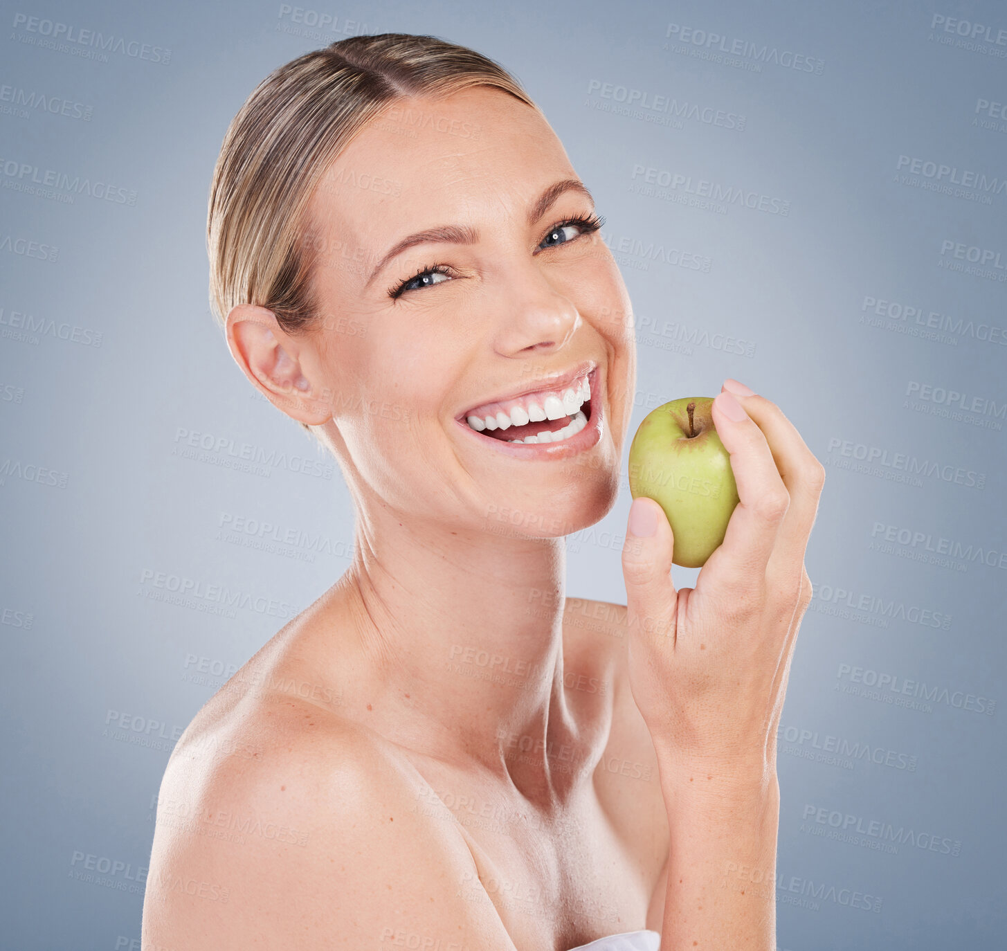 Buy stock photo Skincare, apple and portrait of woman in studio for natural glow, facial treatment or wellness on gray background. Eating, fruit and female model with smile for nutrition, vitamin c or body detox