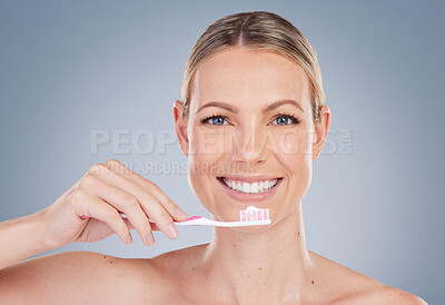 Buy stock photo Woman, portrait and toothbrush with toothpaste in studio, smile and oral hygiene for self care. Mouth, health and cleaning plaque for dental wellness, happy and dentist product for fresh breath