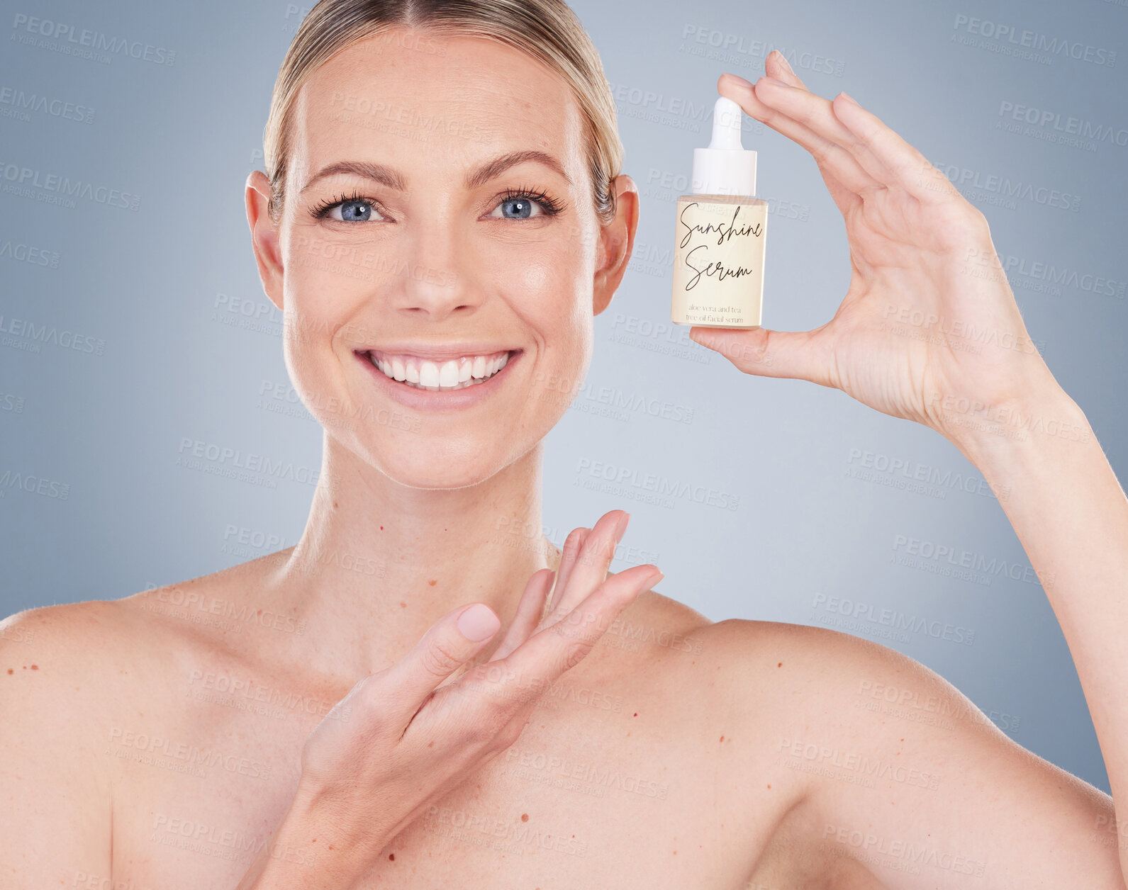 Buy stock photo Woman, portrait and happy with serum bottle for skincare in studio on grey background with routine, ingredients. Girl, natural and confidence with facial treatment, skin product and smile for results