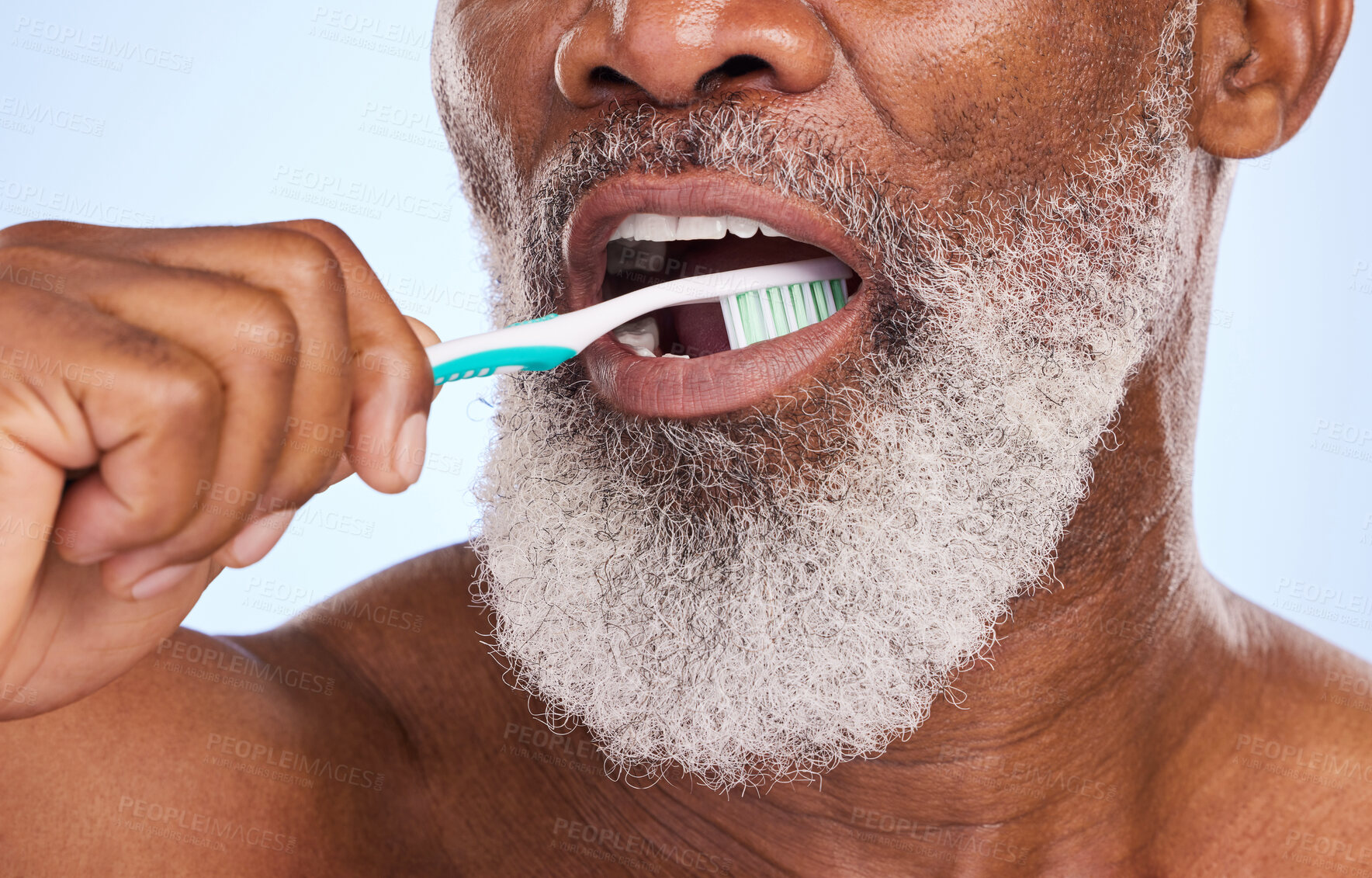 Buy stock photo Brushing teeth, mouth and man for dental healthcare, studio and oral hygiene on blue background. Whitening, clean or routine with tooth brush for person, closeup or toothpaste for fresh breath