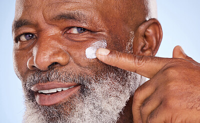 Buy stock photo Skincare, cream and portrait of black man in studio for sunscreen, anti aging or beauty. Cosmetics, closeup or self care with lotion on face of model on blue background for facial, spa and  product