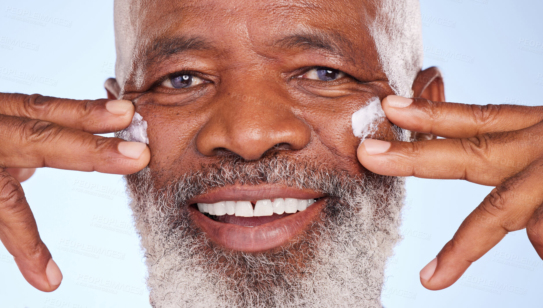 Buy stock photo Beauty, cream and closeup portrait of black man in studio for sunscreen anti aging or skincare. Cosmetics, spa or self care with lotion on face of model on blue background for facial and product