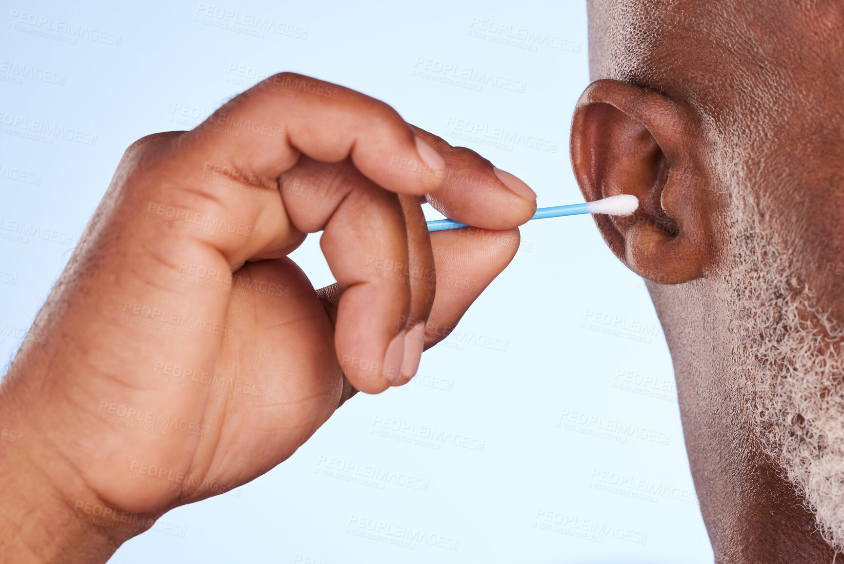 Buy stock photo Studio, man and hand with cotton swab for cosmetics, self care maintenance and removal of wax. Mature person, product and ear with bud for hygiene, health and cleaning of dirt on white background