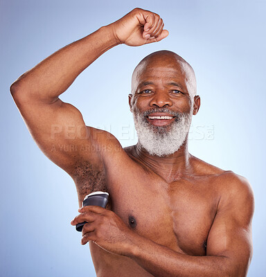 Buy stock photo Studio portrait of a mature man applying deodorant to his armpit against a blue background