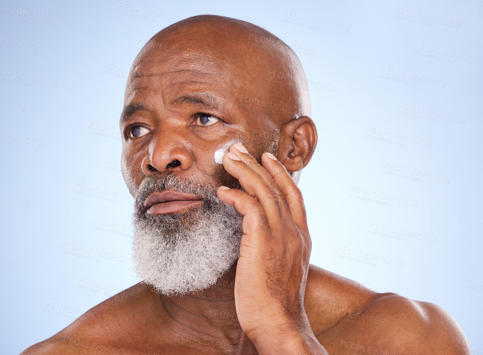 Buy stock photo Skincare, cream and face of black man in studio for sunscreen anti aging or beauty. Cosmetics, mockup or self care with lotion with senior model on blue background for facial, glow and spa product