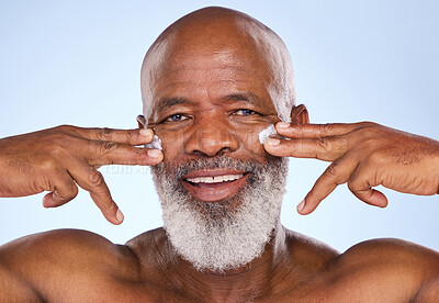 Buy stock photo Skincare, cream and happy with portrait of black man in studio for sunscreen, anti aging or beauty. Cosmetics, mockup or self care with face lotion on model on blue background for facial and product