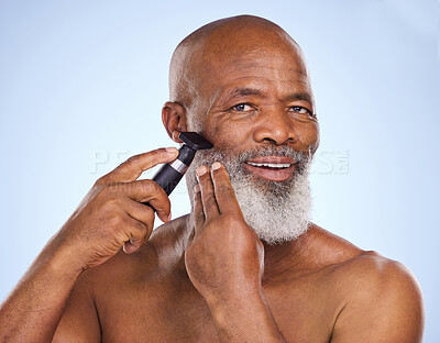 Buy stock photo Portrait, black man and beard with razor for hair removal, grooming and selfcare on blue background. Machine, tools and electric for cosmetic treatment for male person, facial hygiene and equipment