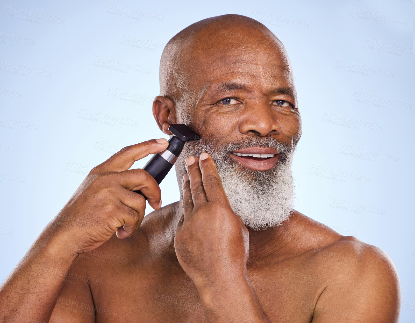 Buy stock photo Portrait, black man and beard with razor for hair removal, grooming and selfcare on blue background. Machine, tools and electric for cosmetic treatment for male person, facial hygiene and equipment