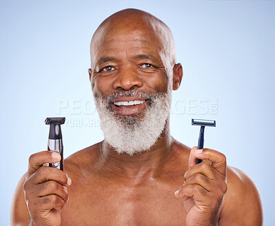 Buy stock photo Portrait, black man and beard with razor for hair removal, grooming and selfcare on blue background. Machine, tools and electric for cosmetic treatment for male person, facial hygiene and choice