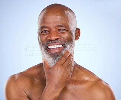 Buy stock photo Studio portrait of a mature man posing against a blue background