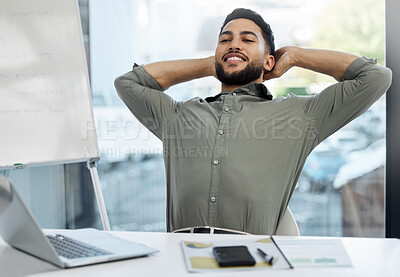 Buy stock photo Shot of a young businessman taking a break in an office at work