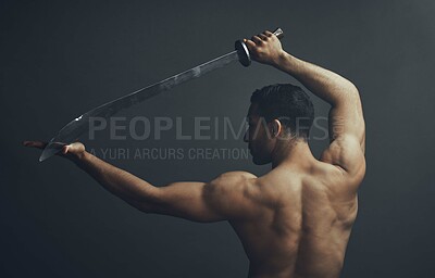 Buy stock photo Shot of an unrecognisable man standing alone in the studio and posing with a broadsword