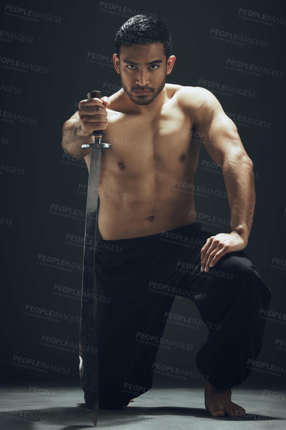 Buy stock photo Portrait, kneeling and Asian man with sword in studio for wellness, exercise and fitness or martial arts. Warrior, training and blade for ninja by black background for karate for dojo in Japan