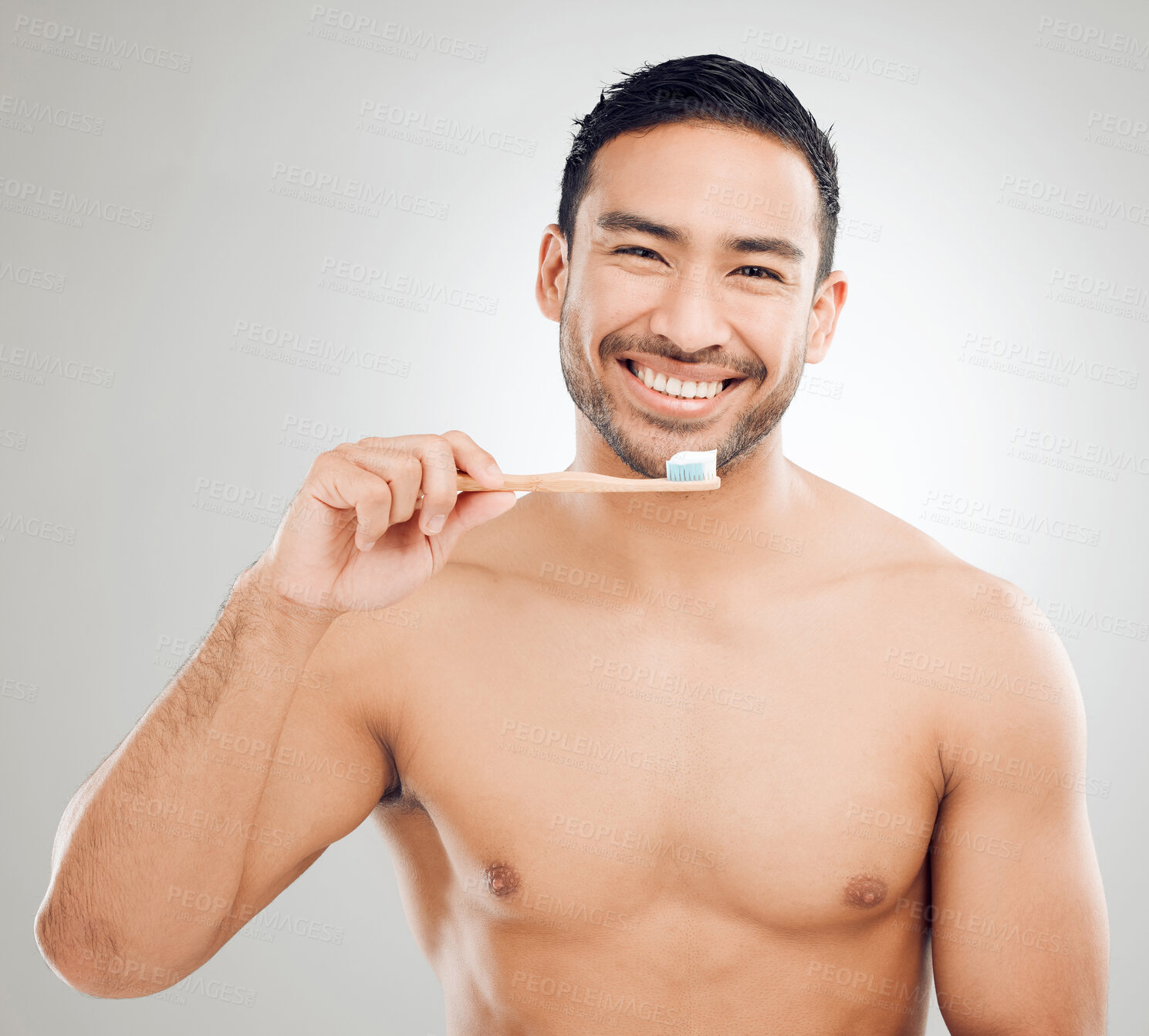 Buy stock photo Portrait, man and brushing teeth for hygiene with healthy gums and toothpaste with whitening results in studio. Asian guy, dental and bamboo brush for clean mouth and fresh breath by white background