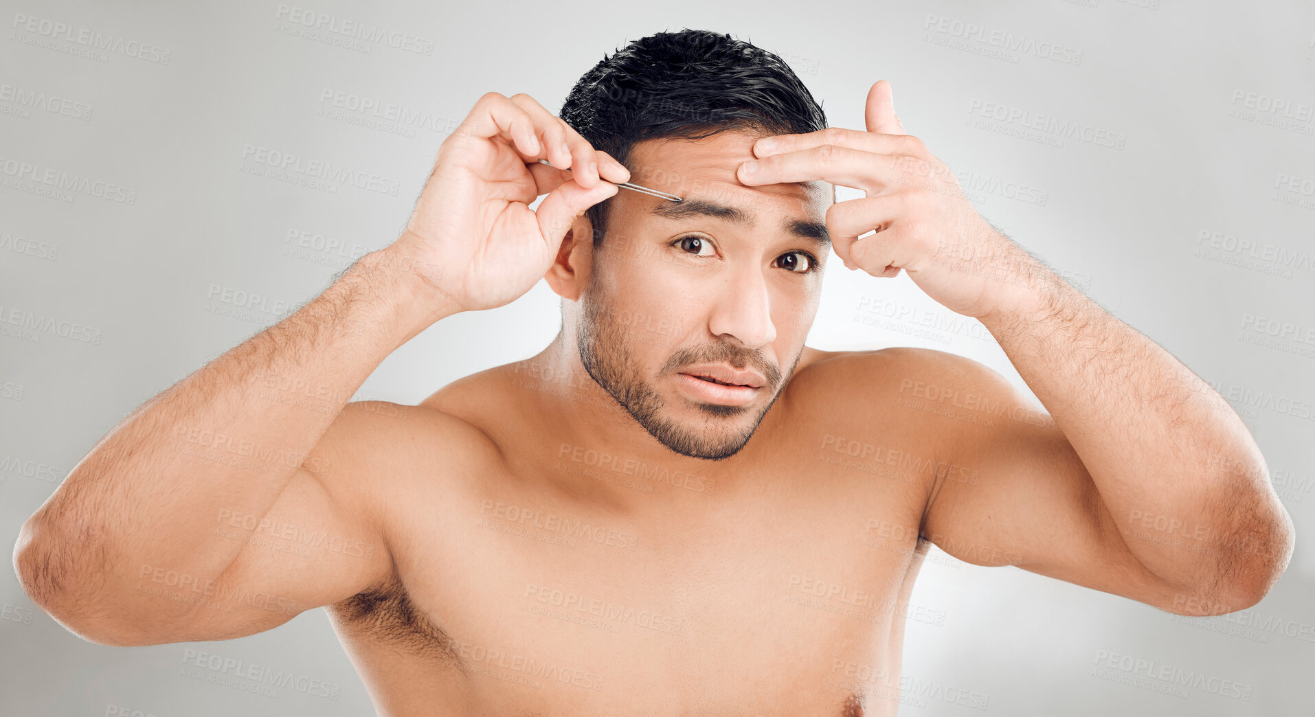 Buy stock photo Man, tweezers and eyebrow in studio portrait, grooming and plucking for epilation on white background. Male person, skincare and maintenance for hygiene routine or clean, beauty and facial cosmetics