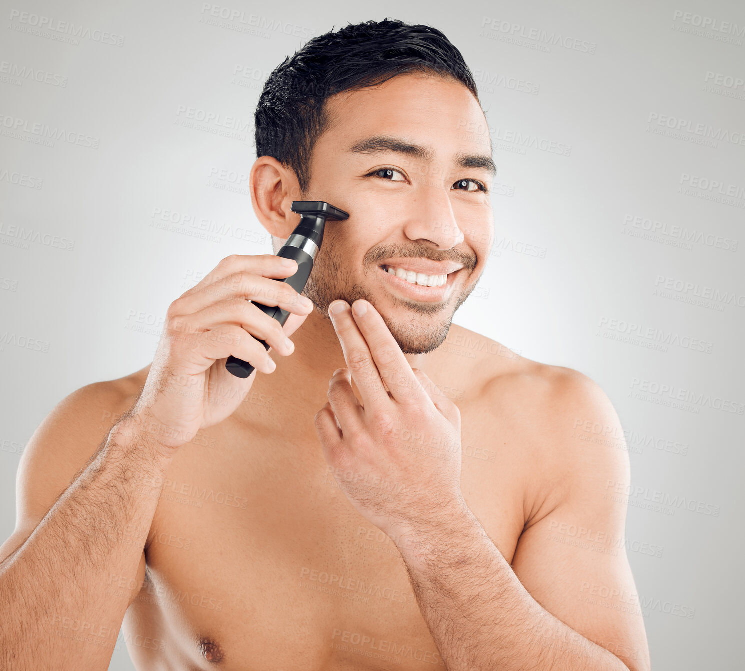 Buy stock photo Electric, shaving and portrait of man in studio for morning routine, wellness or natural treatment on white background. Grooming, body and asian model with razor for confidence, facial or skincare