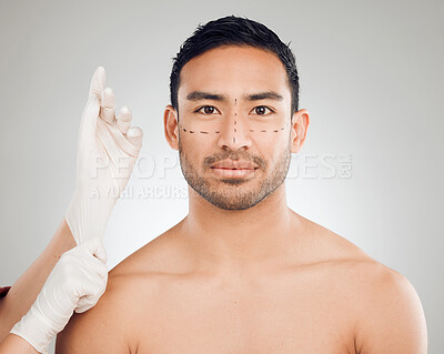 Buy stock photo Male person, hands and drawing marks on face for plastic surgery, rhinoplasty and cosmetic procedure in studio. Man, surgeon and needle or syringe placement for facelift, nose job and blepharoplasty