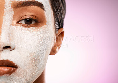 Buy stock photo Studio shot of an attractive young woman having a facial against a pink background