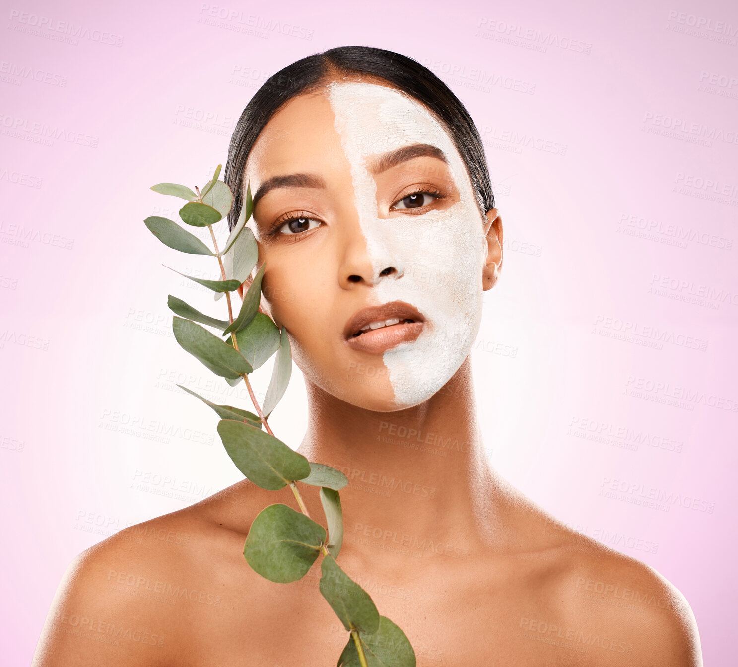 Buy stock photo Woman, facial mask and leaves in studio portrait, vegan and organic skincare on pink background. Female person, plant and half for comparison results, eco friendly cosmetics and natural dermatology