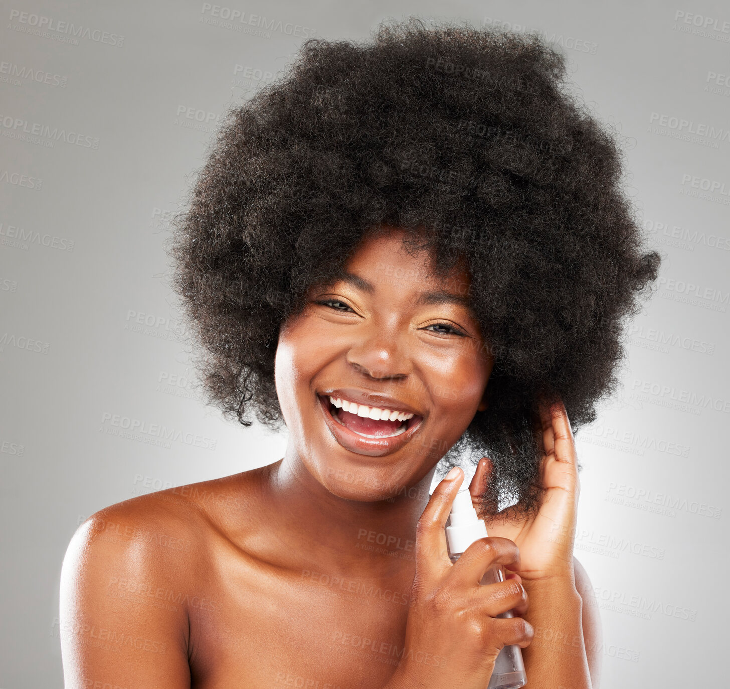 Buy stock photo Portrait, afro and happy model with hair spray in studio for cosmetics, natural treatment or grooming on gray background. Body, beauty and black woman with product for frizz control, shine or curly