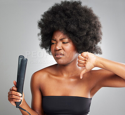 Buy stock photo Woman, flat iron and thumbs down for product or straightner aesthetic for healthy growth or natural treatment. Female person, hair damage and afro for shine, volume and cosmetics in studio background